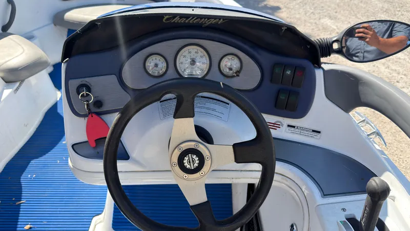 Slide: The Image of The image shows the helm of a Sea-Doo Challenger 2000 with a steering wheel and gauges. - 14