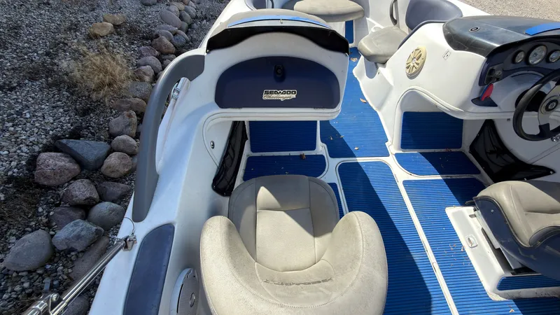 Slide: The Image of The image shows the cockpit of a 2002 Sea-Doo Challenger 2000 with blue floor mats. - 11