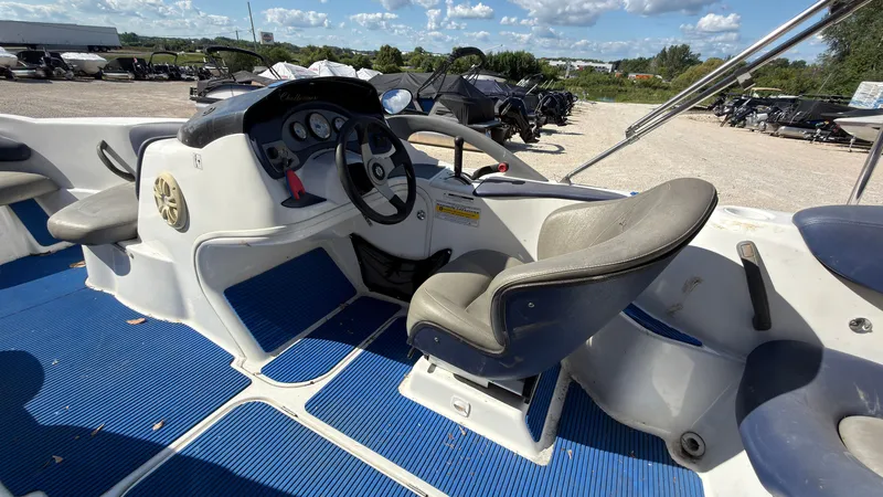 Slide: The Image of The image shows the cockpit of a 2002 Sea-Doo Challenger 2000 with blue floor mats. - 13