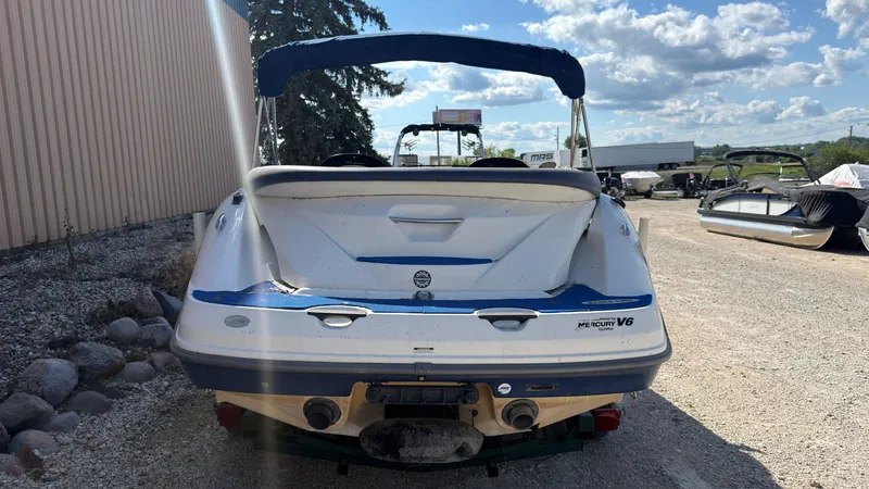 Slide: The Image of A 2002 Sea-Doo Challenger 2000 on a gravel lot. The sky is partly cloudy. - 3