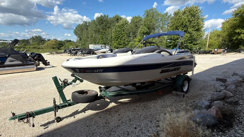 Slide: The Image of A 2002 Sea-Doo Challenger 2000 on a trailer in a gravel lot. - 6