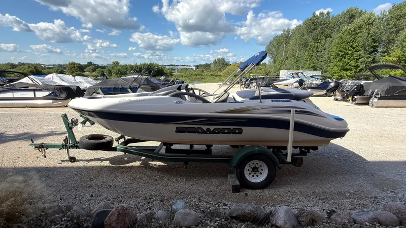 Slide: The Image of A 2002 Sea-Doo Challenger 2000 on a trailer in a gravel lot. - 5