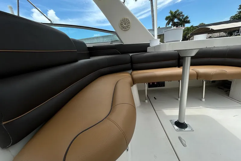 Slide: The Image of Luxurious seating area on a 2000 Monterey 330 Sport Yacht, featuring brown and black upholstery. - 10