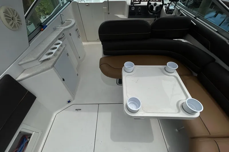 Slide: The Image of Interior of a 2000 Monterey 330 Sport Yacht with seating and table setup. - 11