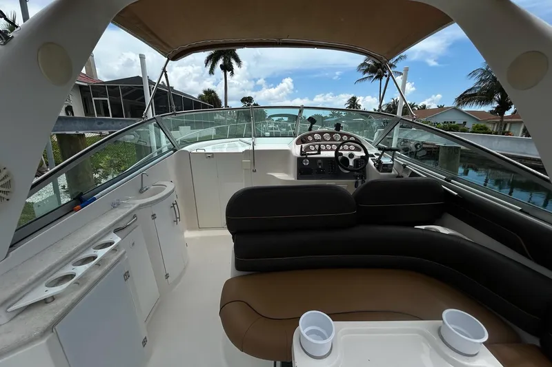 Slide: The Image of Interior view of a 2000 Monterey 330 Sport Yacht with seating and control panel. - 12