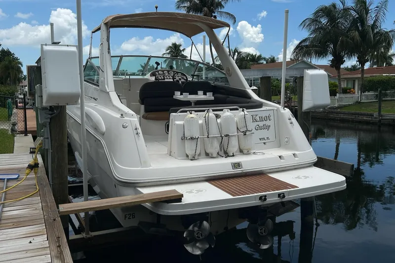Slide: The Image of 2000 Monterey 330 Sport Yacht docked, featuring a sleek design and spacious deck area. - 2