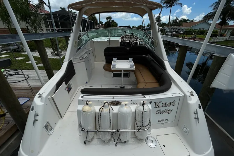 Slide: The Image of 2000 Monterey 330 Sport Yacht docked, featuring spacious seating and scuba tanks. - 3