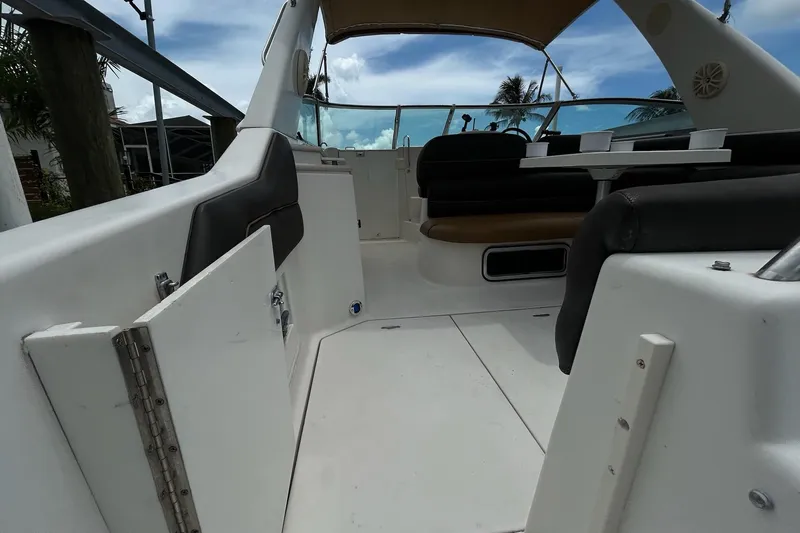 Slide: The Image of Interior view of a 2000 Monterey 330 Sport Yacht, featuring seating and a table. - 6