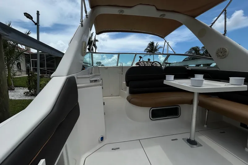 Slide: The Image of Interior view of a 2000 Monterey 330 Sport Yacht with seating and table under a canopy. - 7