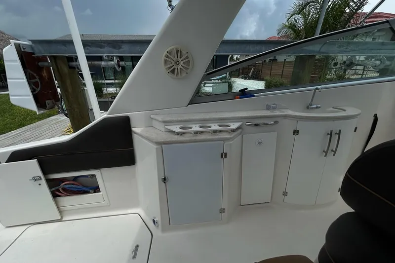 Slide: The Image of Interior view of a 2000 Monterey 330 Sport Yacht featuring a kitchenette and seating area. - 8