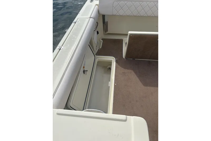 Slide: The Image of 2017 Chris-Craft Calypso 26 boat interior with open storage compartments. - 18