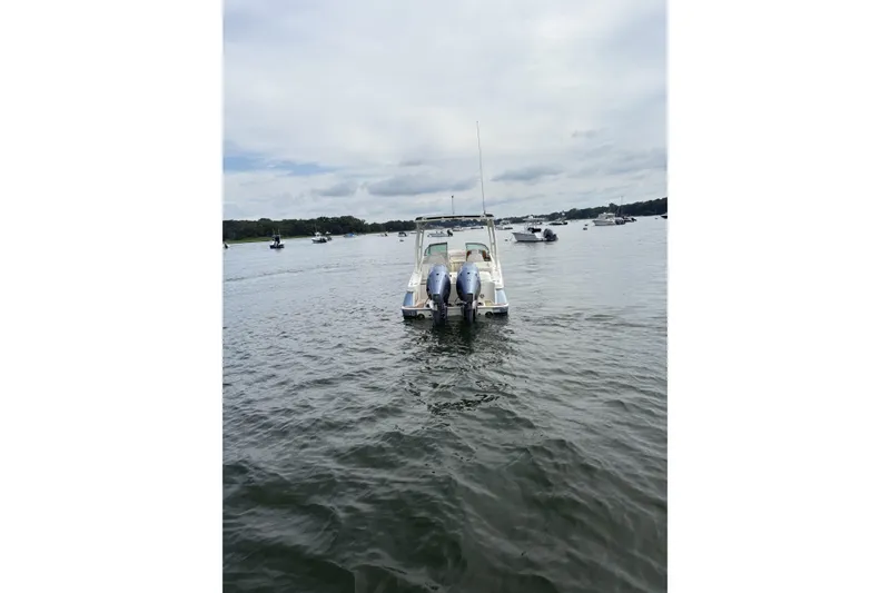 Slide: The Image of 2017 Chris-Craft Calypso 26 boat on calm water, rear view. - 4