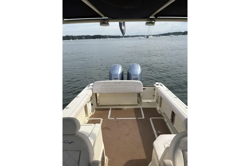 Slide: The Image of 2017 Chris-Craft Calypso 26 boat with dual engines on a calm lake. - 16