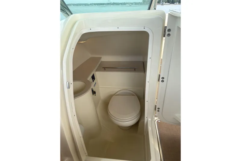 Slide: The Image of 2017 Chris-Craft Calypso 26 boat interior bathroom with toilet and sink. - 21