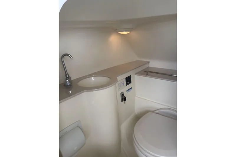 Slide: The Image of 2017 Chris-Craft Calypso 26 boat bathroom with sink, faucet, and toilet. - 22