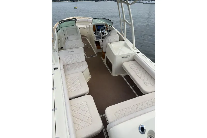 Slide: The Image of 2017 Chris-Craft Calypso 26 boat interior with luxurious seating and steering console. - 10