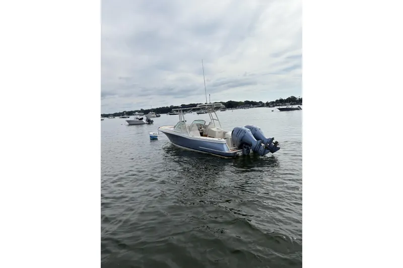 Slide: The Image of 2017 Chris-Craft Calypso 26 boat on calm water with twin outboard engines. - 3