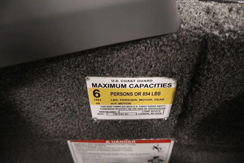Slide: The Image of U.S. Coast Guard capacity label on 2027 Lowe Fishing Machine 1625SC, showing limits for persons and weight. - 35