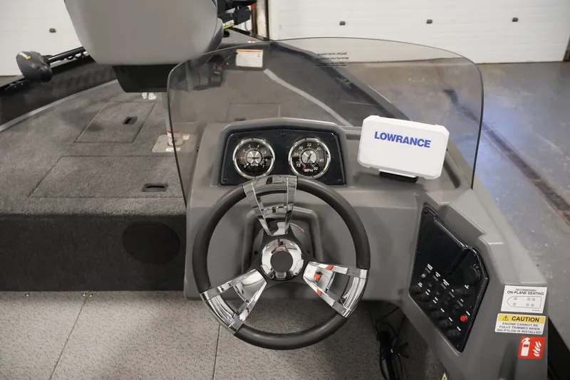 Slide: The Image of 2027 Lowe Fishing Machine 1625SC dashboard with steering wheel and Lowrance navigation system. - 30