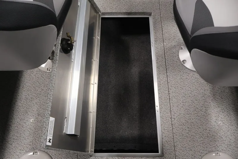 Slide: The Image of 2027 Lowe Fishing Machine 1625SC boat interior storage compartment with gray carpet and seating. - 22