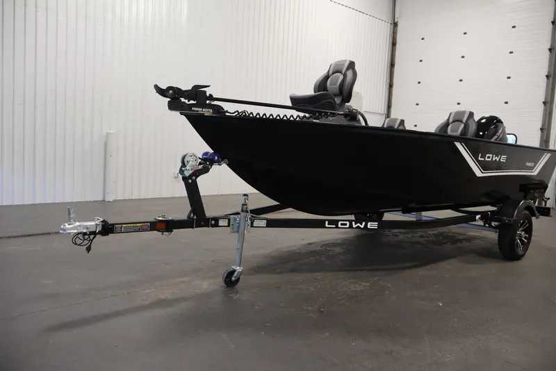Slide: The Image of 2027 Lowe Fishing Machine 1625SC boat on trailer in indoor setting. - 25