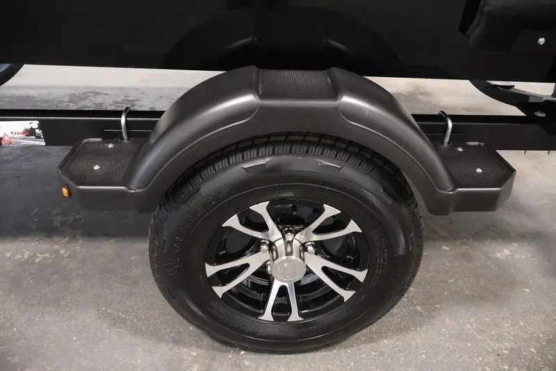 Slide: The Image of 2027 Lowe Fishing Machine 1625SC trailer wheel with black fender and alloy rim. - 23