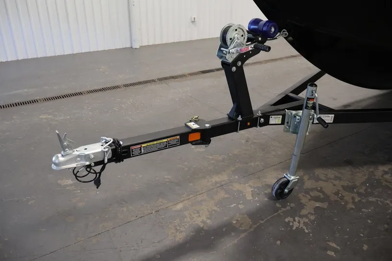 Slide: The Image of Trailer hitch of 2027 Lowe Fishing Machine 1625SC, featuring a sturdy wheel and winch. - 32