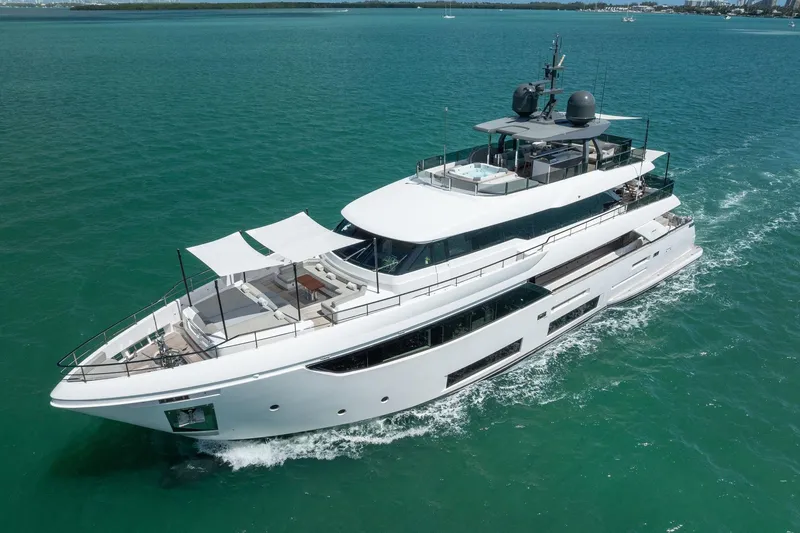 Slide: The Image of Luxurious 2023 Custom Line Navetta 33 yacht cruising on clear blue waters. - 11