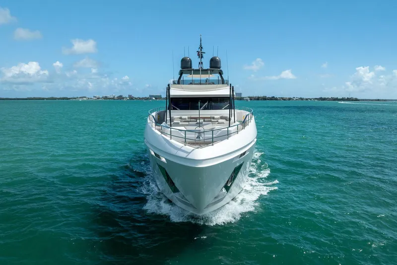 Slide: The Image of Luxurious 2023 Custom Line Navetta 33 yacht cruising in turquoise waters under clear skies. - 12