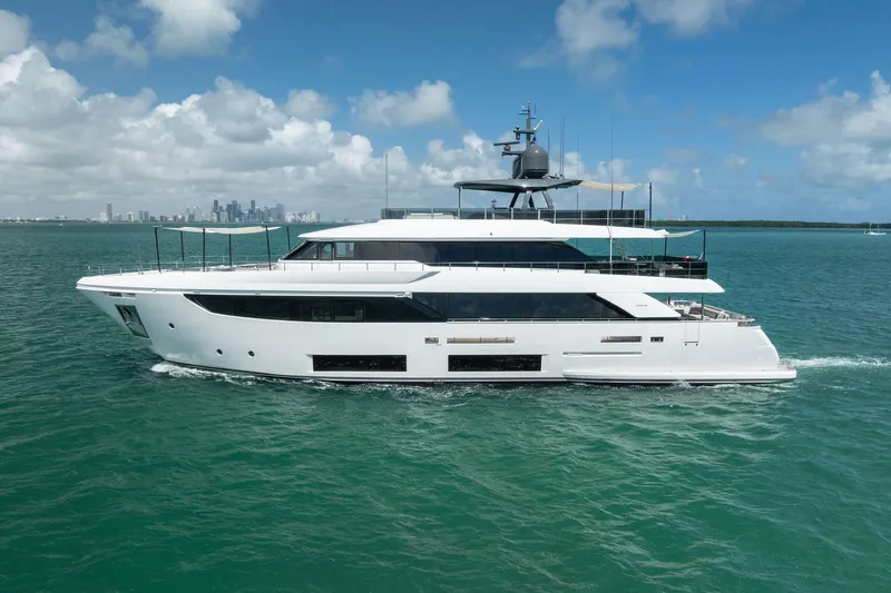 Slide: The Image of Luxurious 2023 Custom Line Navetta 33 yacht cruising on turquoise waters under a clear sky. - 159