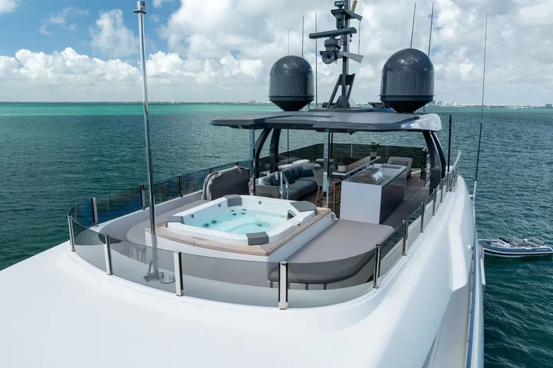 Slide: The Image of Luxurious 2023 Custom Line Navetta 33 yacht with jacuzzi on deck, cruising in clear waters. - 16