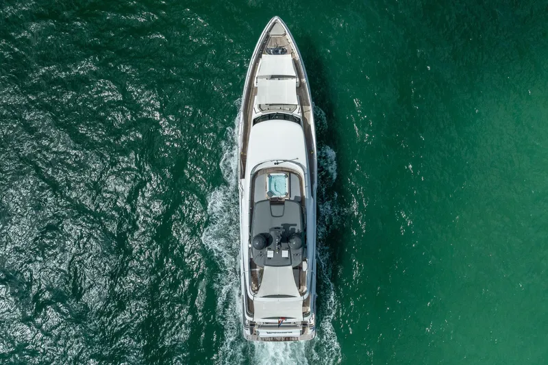Slide: The Image of Aerial view of 2023 Custom Line Navetta 33 yacht cruising in clear blue waters. - 18