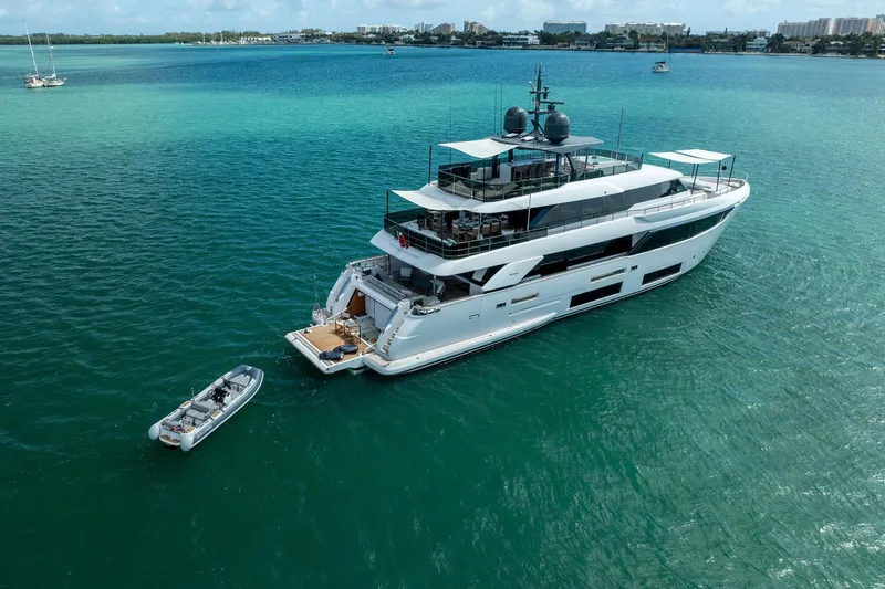 Slide: The Image of Luxurious 2023 Custom Line Navetta 33 yacht anchored in turquoise waters. - 6