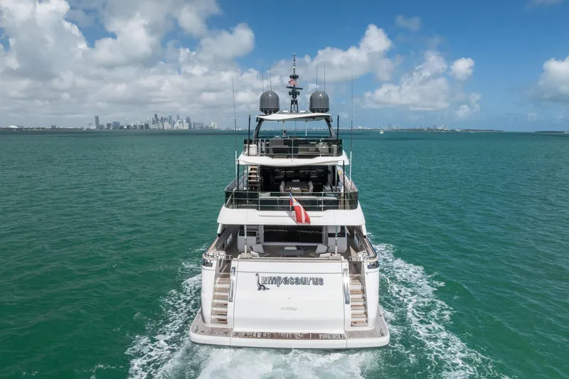 Slide: The Image of Luxurious 2023 Custom Line Navetta 33 yacht cruising on turquoise waters under a clear sky. - 7