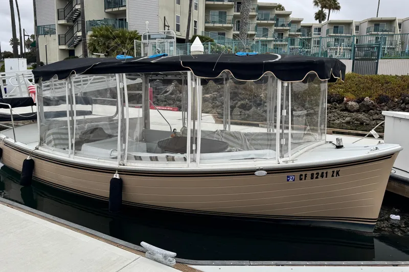 The Image of 2023 Duffy Bay Cruiser docked at marina with clear canopy and black roof. - 1