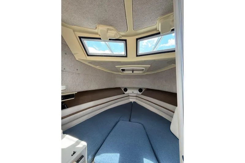 Slide: The Image of Interior cabin of 1999 Grady-White Islander 268 boat with blue cushions and windows. - 13