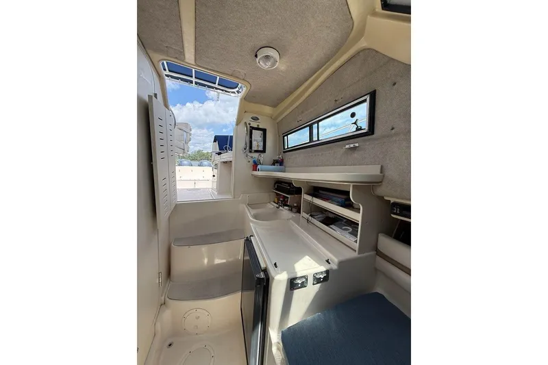 Slide: The Image of Interior cabin of 1999 Grady-White Islander 268 boat, featuring seating and storage. - 15