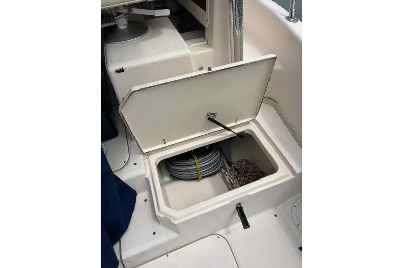 Slide: The Image of Open storage compartment on 1999 Grady-White Islander 268 boat, containing coiled rope. - 19