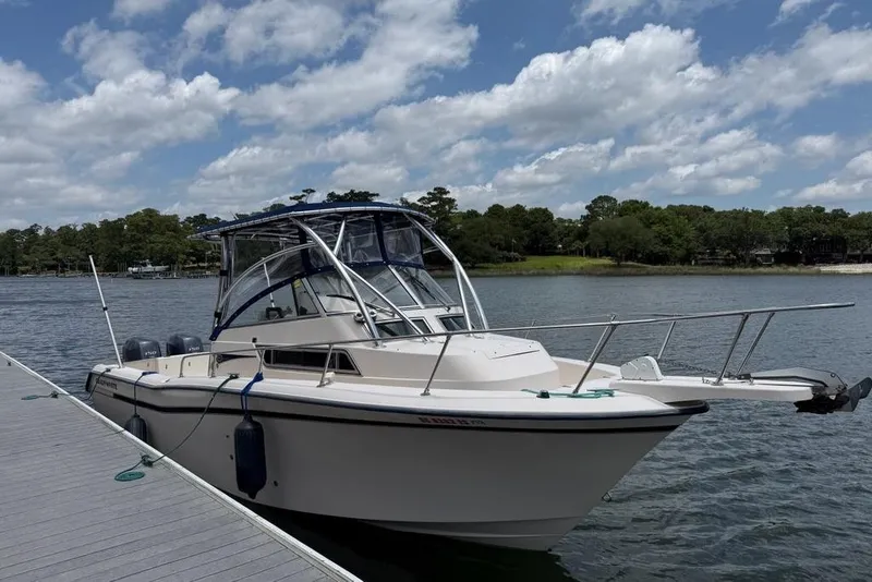 Slide: The Image of 1999 Grady-White Islander 268 boat docked on a sunny day with blue skies. - 2