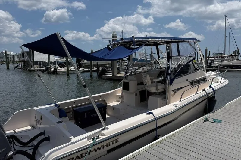 Slide: The Image of 1999 Grady-White Islander 268 boat docked at marina under blue sky. - 8
