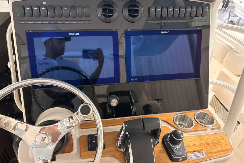 Slide: The Image of 2026 Boston Whaler 380 Outrage helm with dual Simrad displays and modern controls. - 16
