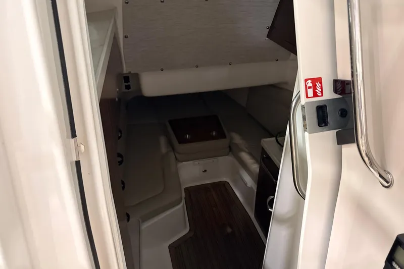 Slide: The Image of Interior cabin of 2026 Boston Whaler 380 Outrage boat, featuring seating and wooden flooring. - 18