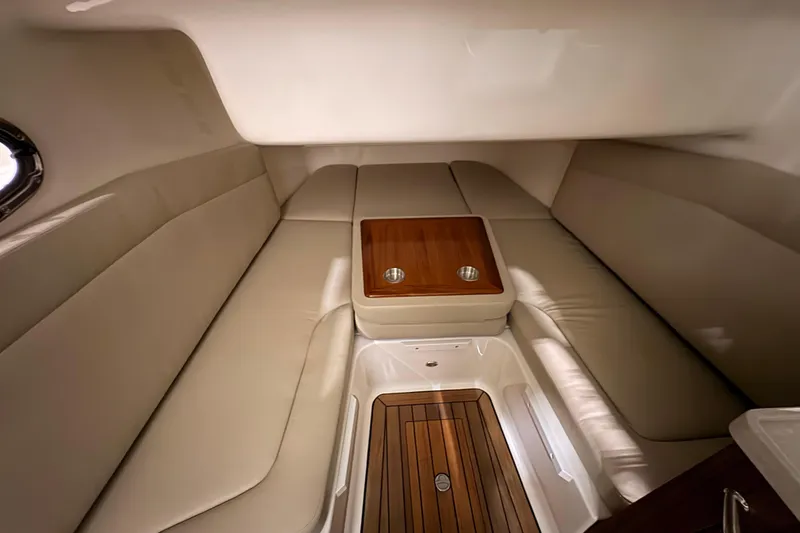 Slide: The Image of Luxurious cabin interior of 2026 Boston Whaler 380 Outrage with elegant seating and wood accents. - 20