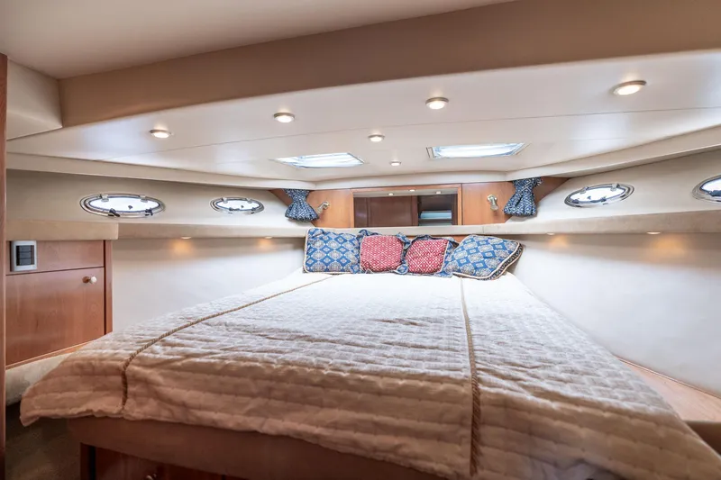 Slide: The Image of Luxurious 2003 Meridian 490 Pilothouse bedroom with cozy bedding and elegant lighting. - 26