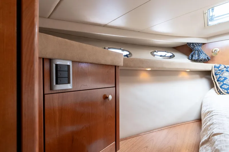 Slide: The Image of Interior of 2003 Meridian 490 Pilothouse, featuring wood cabinetry and cozy sleeping area. - 29
