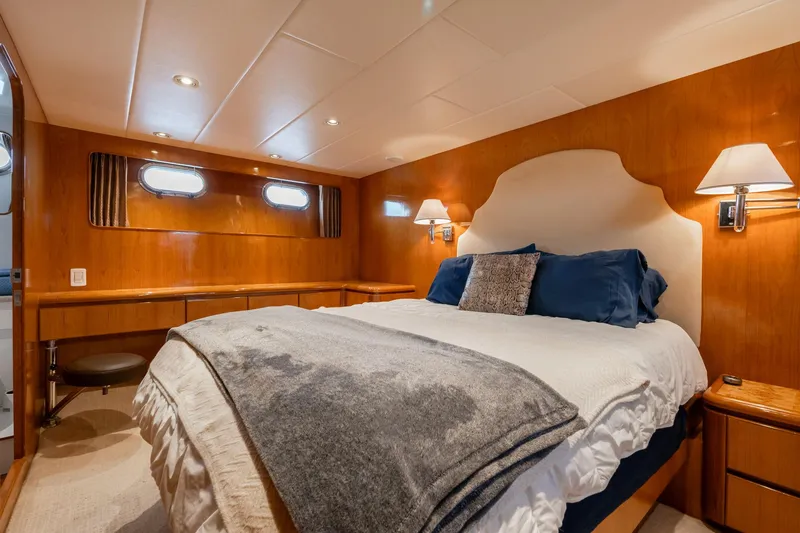 Slide: The Image of Luxurious bedroom in 1999 Vitech 68' Pilothouse yacht with elegant wood paneling and cozy bedding. - 46