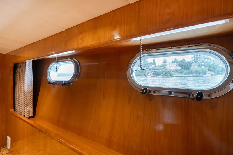 Slide: The Image of 1999 Vitech 68' Pilothouse interior with wooden paneling and oval windows. - 48