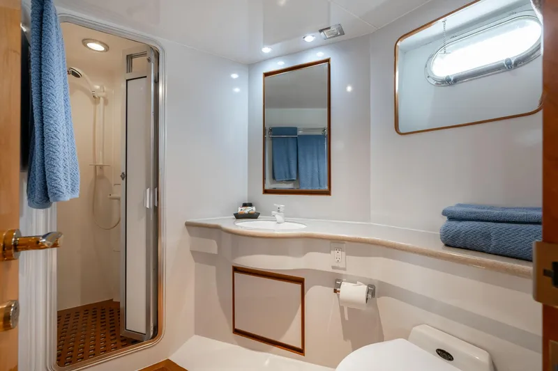 Slide: The Image of A sleek yacht bathroom with a shower, sink, and toilet. - 50
