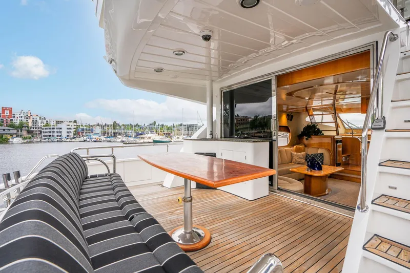Slide: The Image of 1999 Vitech 68' Pilothouse yacht with elegant deck seating and marina view. - 6