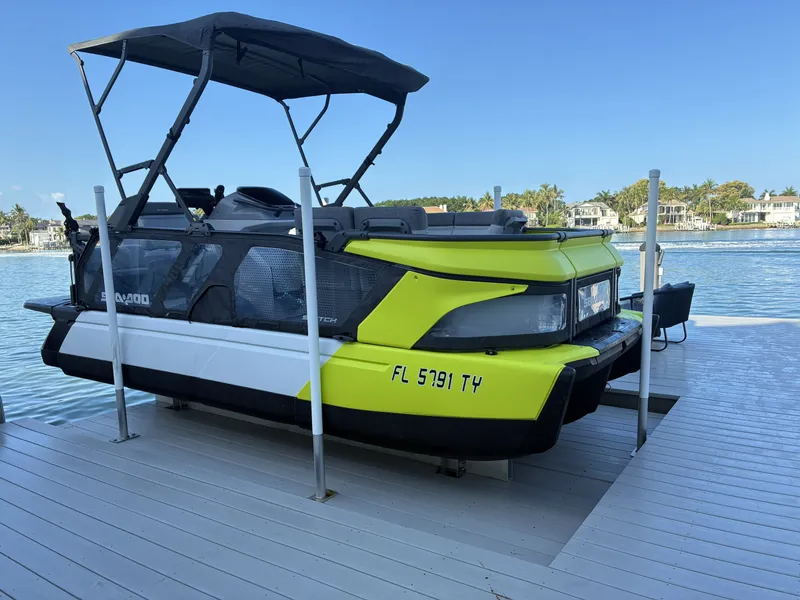 The Image of A Sea-Doo Switch boat on a dock with blue water in the background. - 0